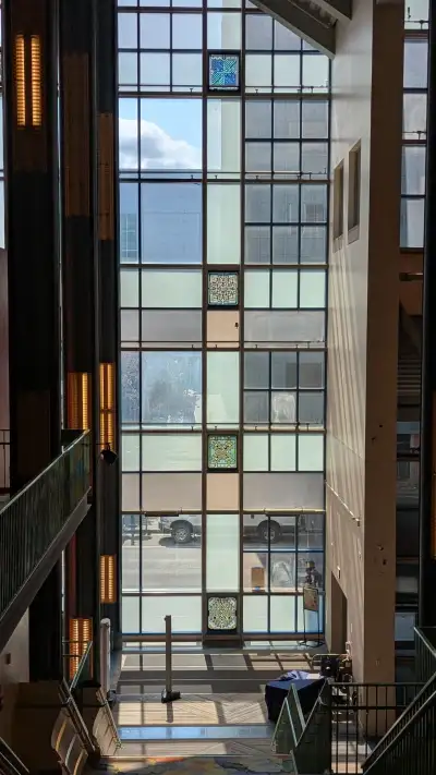 A view of 4 marble windows down the staircase at the ACPA