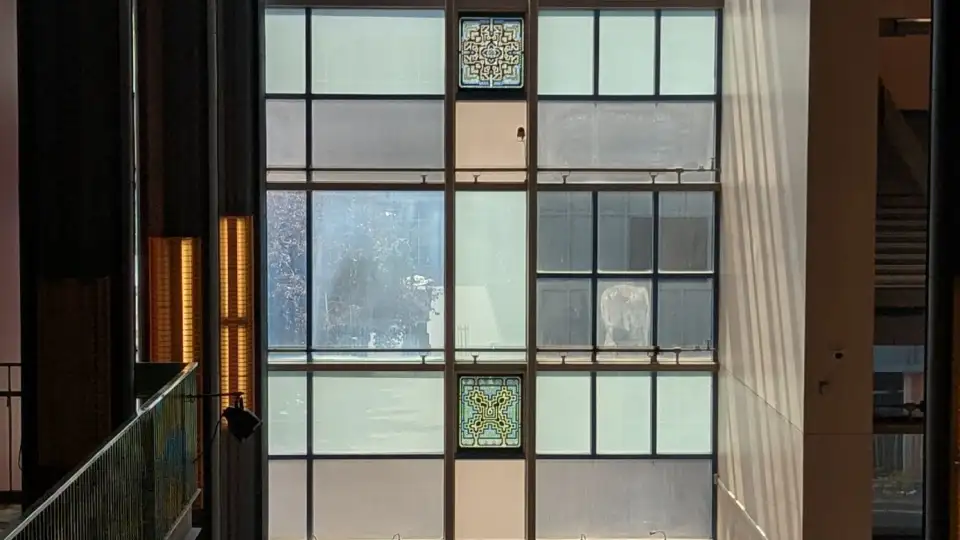 A view of 4 marble windows down the staircase at the ACPA
